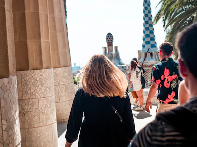 a group of people walking down a sidewalk