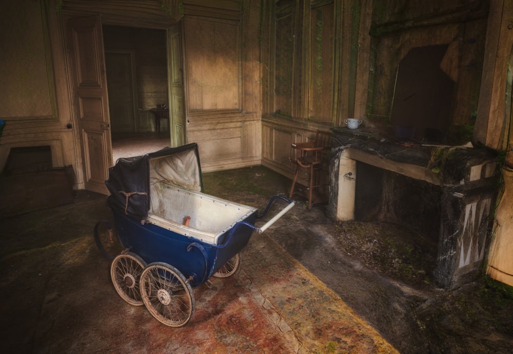 a baby carriage in a room with a fireplace