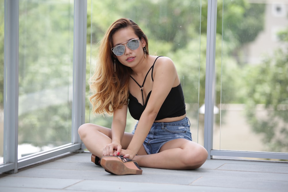 a woman sitting on the floor with her legs crossed