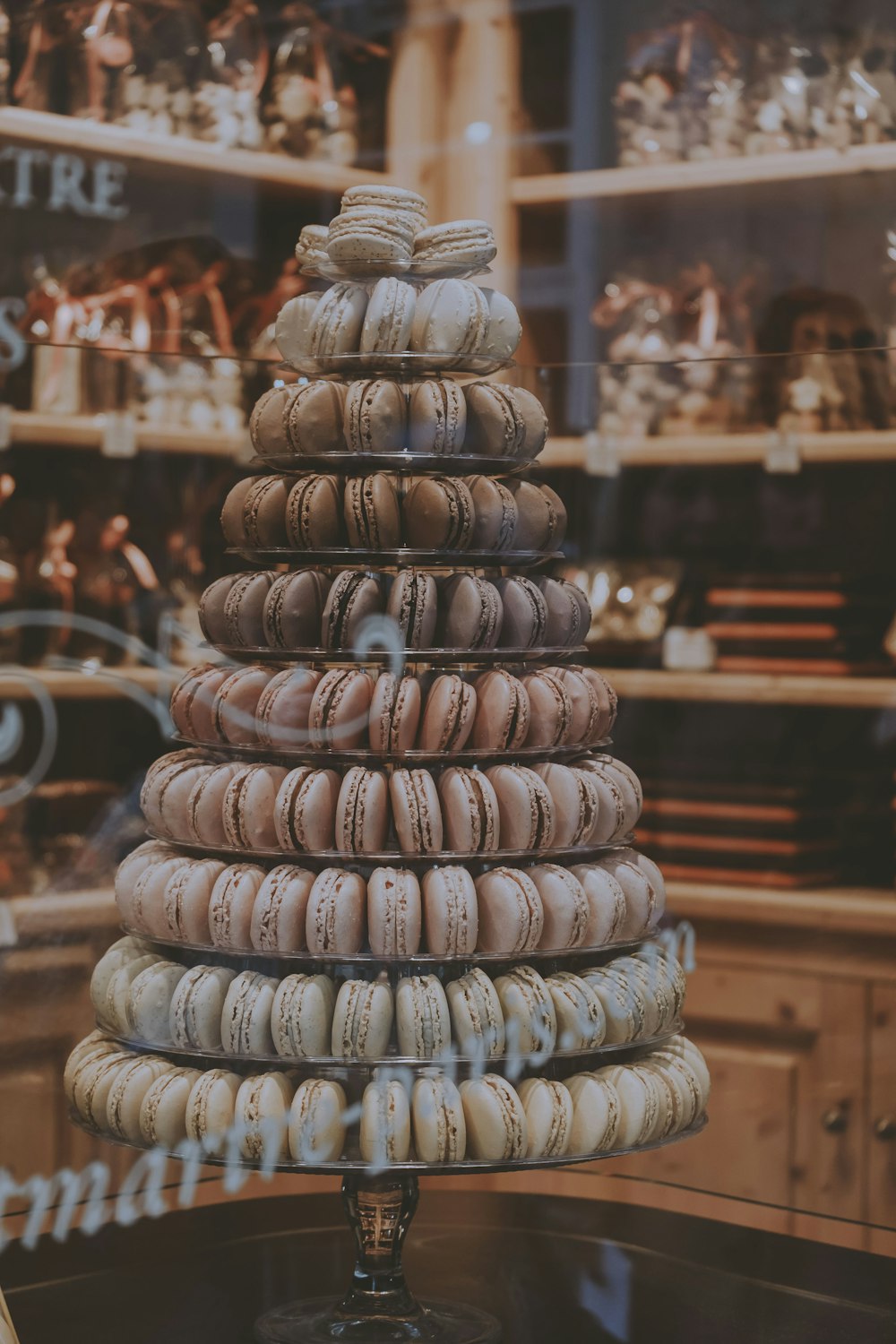 a stack of macaroons sitting on top of a glass table