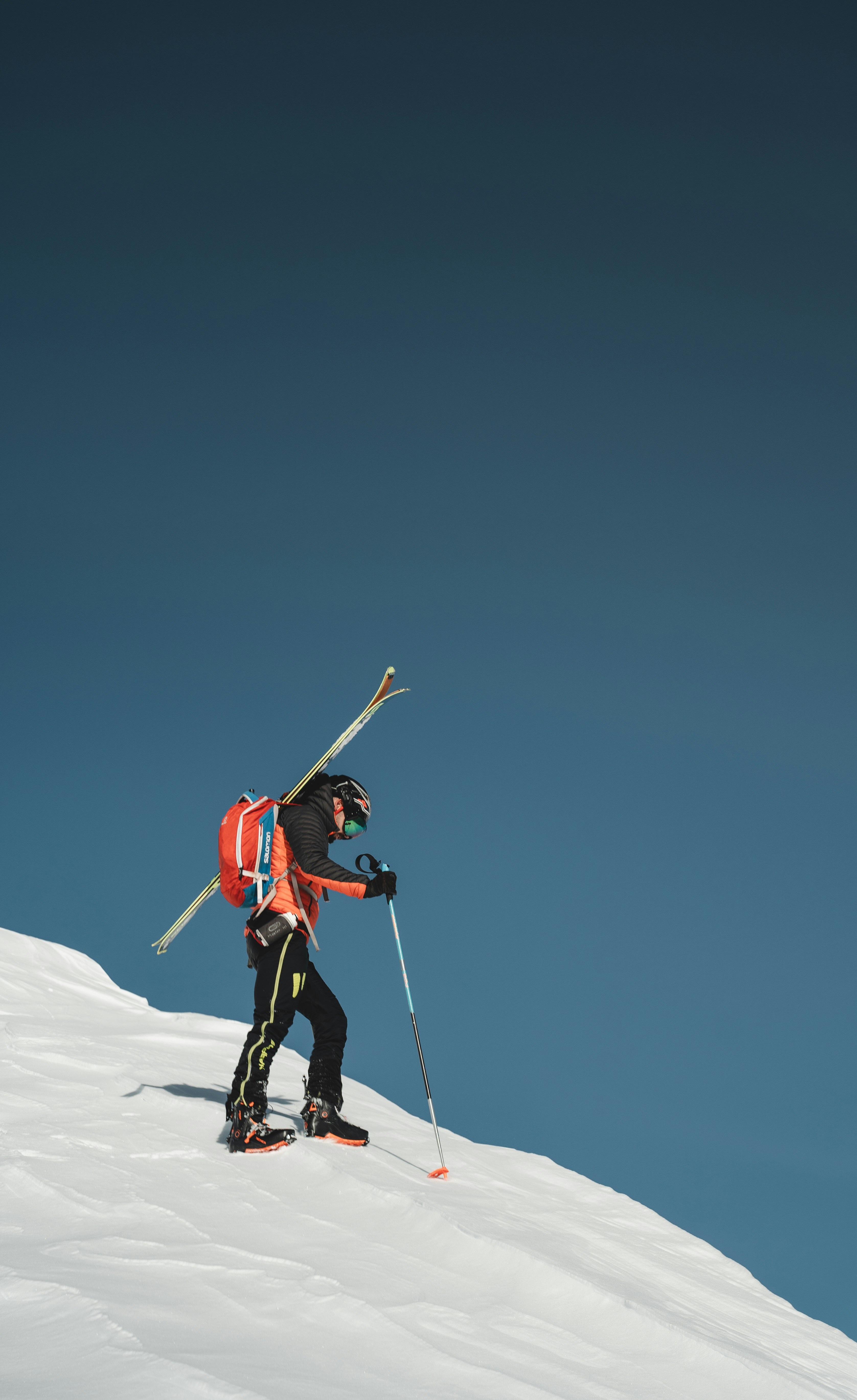 a man riding skis down a snow covered slope