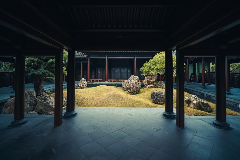 a view of a japanese garden with rocks and grass