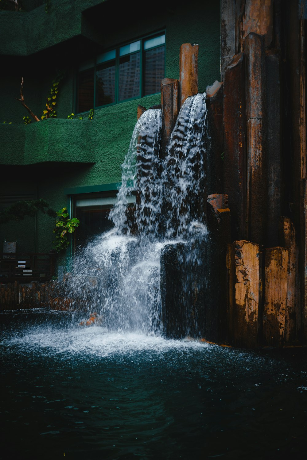 a large water fall in front of a building