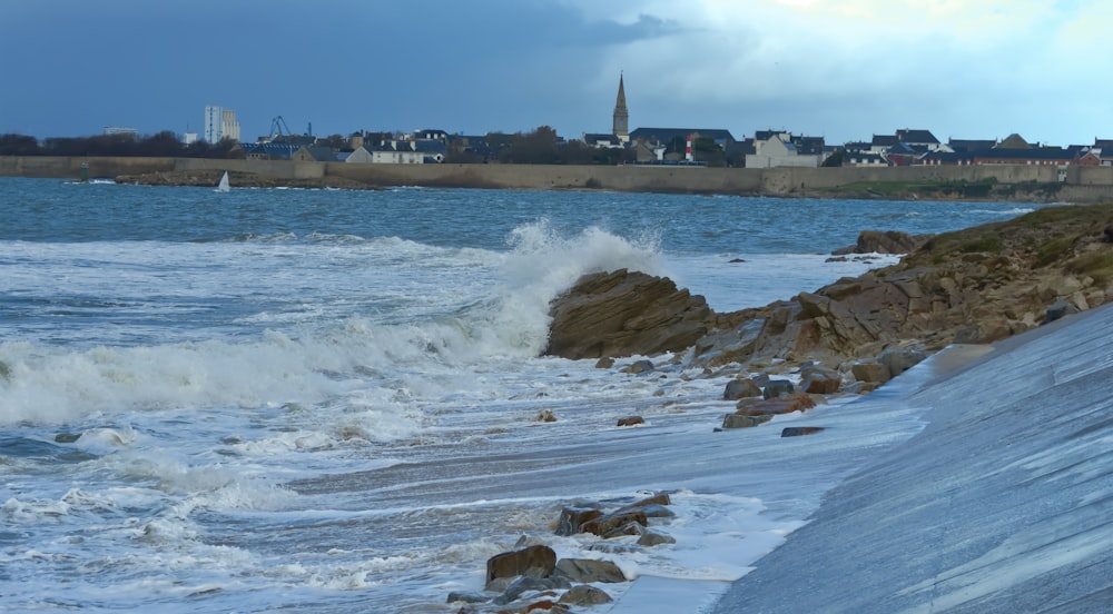 a large body of water next to a rocky shore