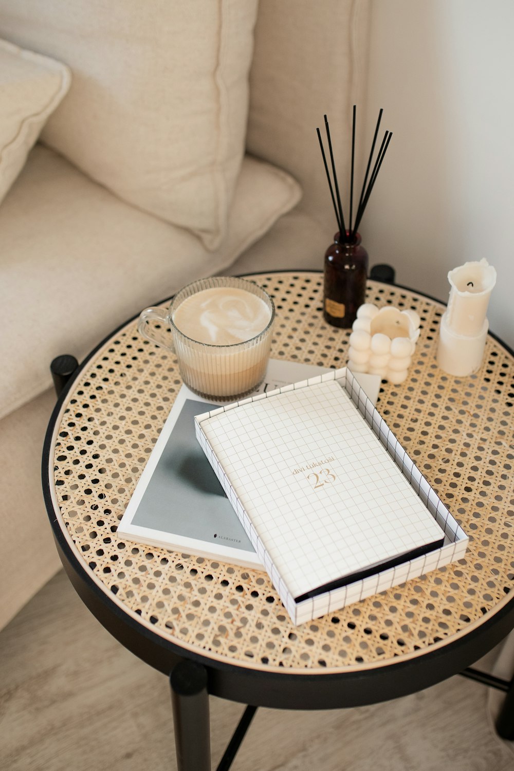 a coffee table with a notebook, candle and a candle holder