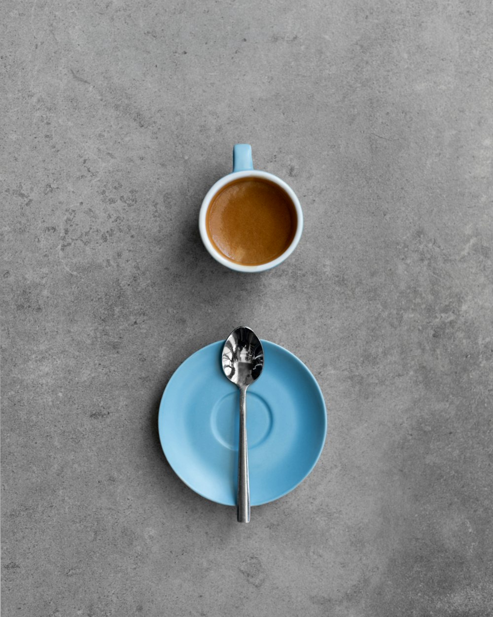 a cup of coffee and a spoon on a plate