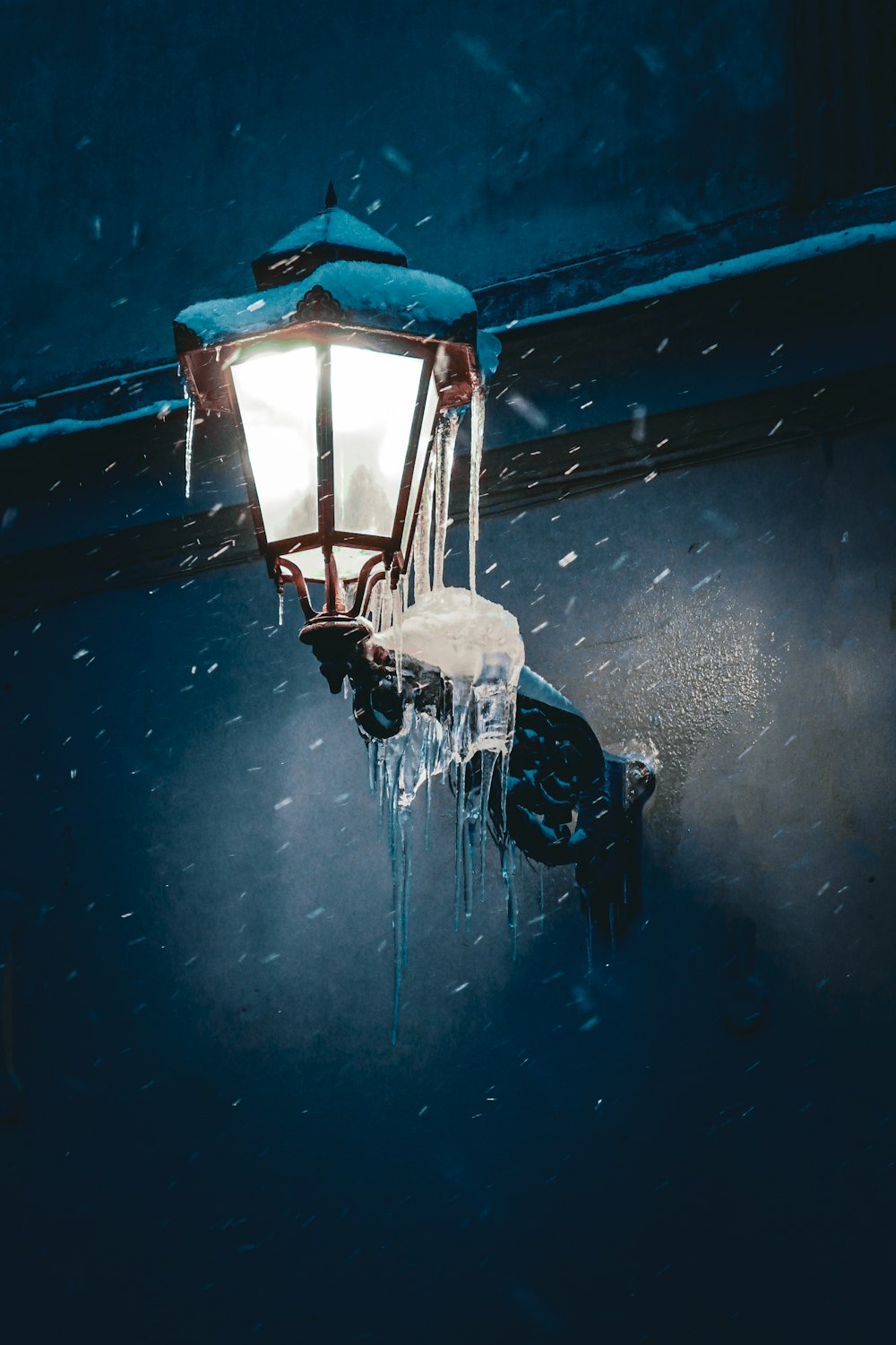 a street light with icicles hanging from it