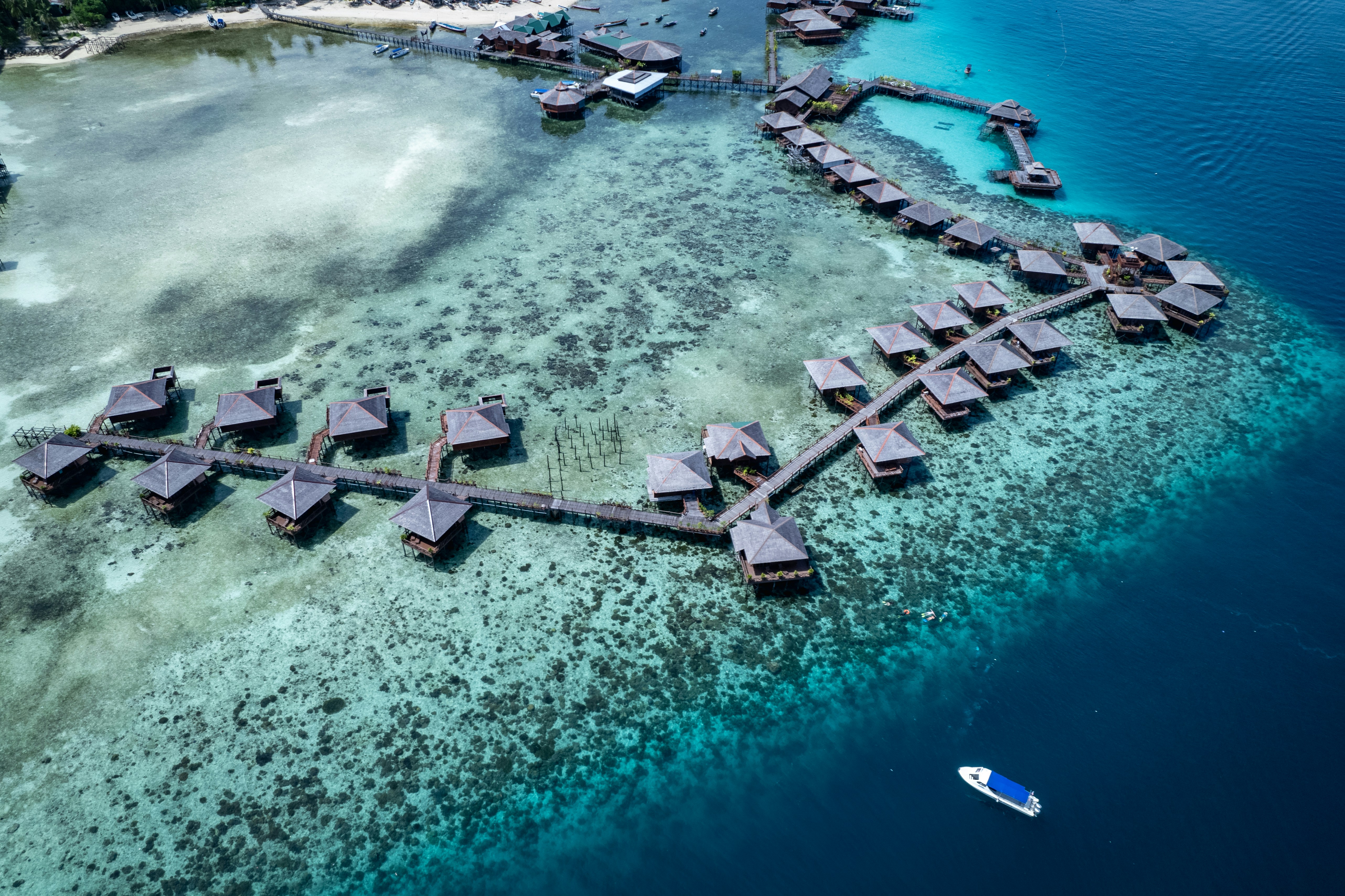 an aerial view of a resort in the ocean