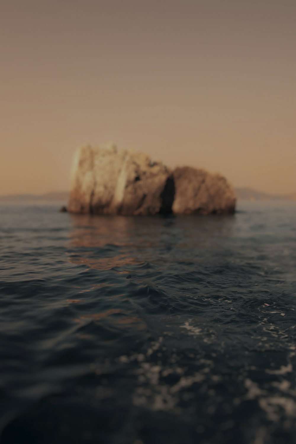 a rock in the middle of a body of water