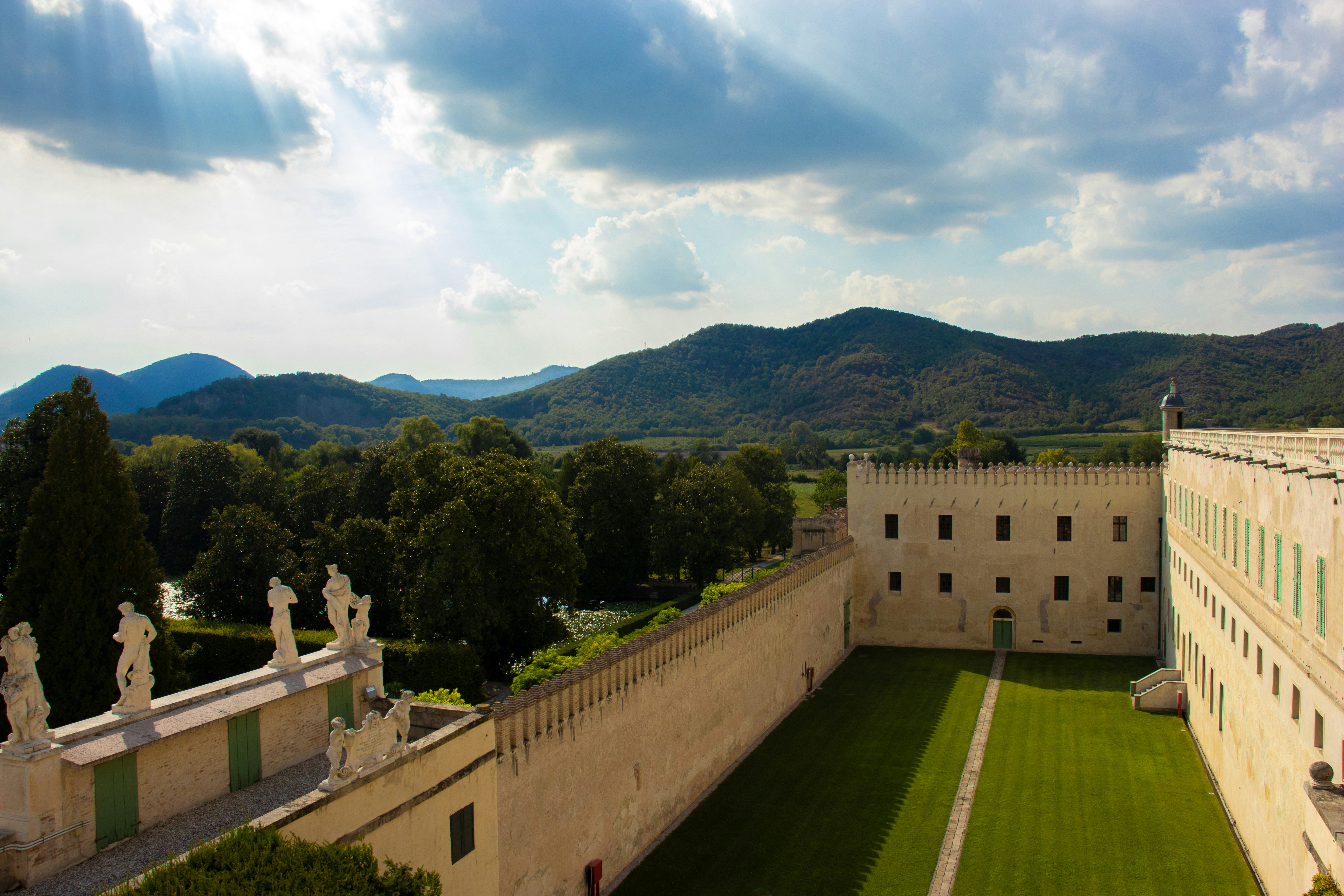 an aerial view of a large building with statues on it