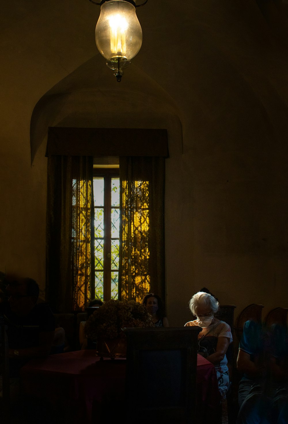 a woman sitting in a chair in front of a window