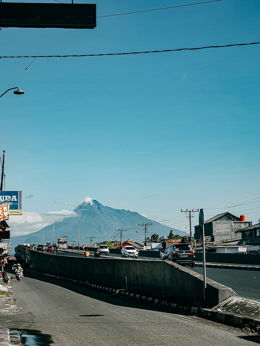 a view of a street with a mountain in the background