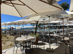 an outdoor dining area with tables and umbrellas