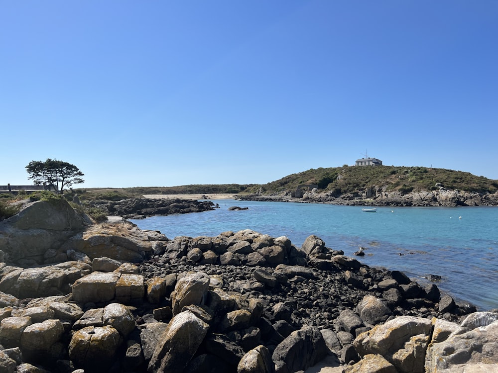 a rocky shore with a small island in the distance