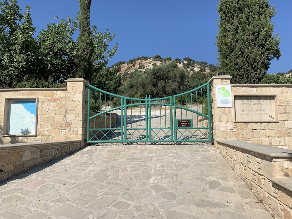 a gated entrance to a park with a mountain in the background
