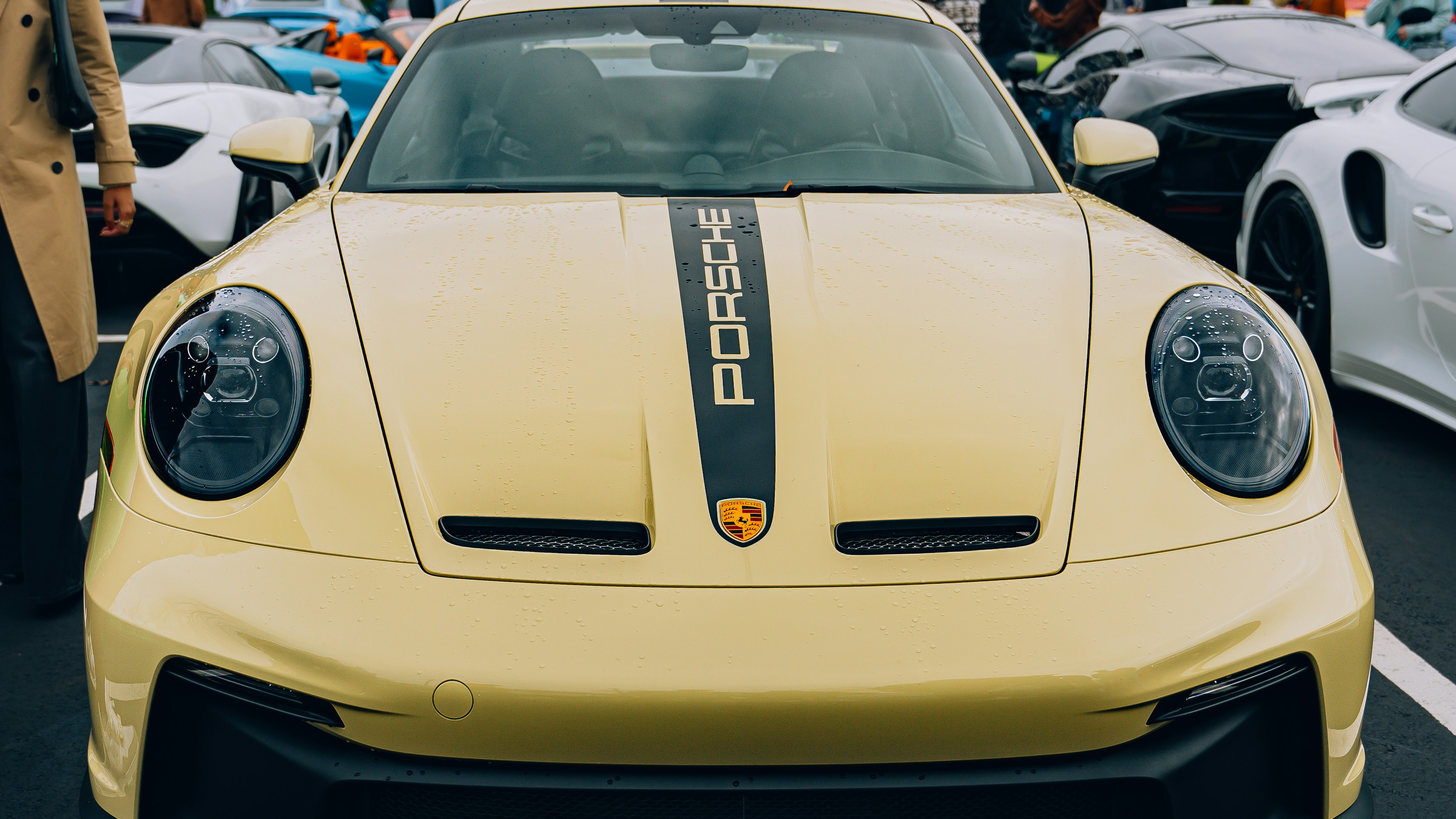 a yellow sports car parked in a parking lot