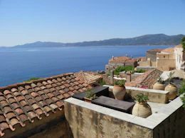 a view of the ocean from the roof of a house