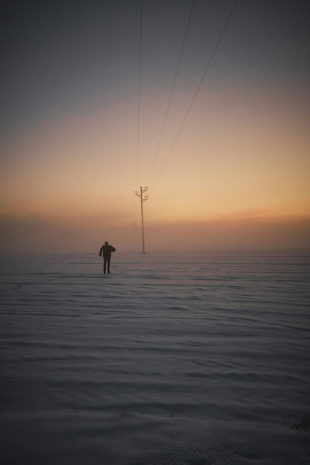 a person standing in the middle of a frozen lake