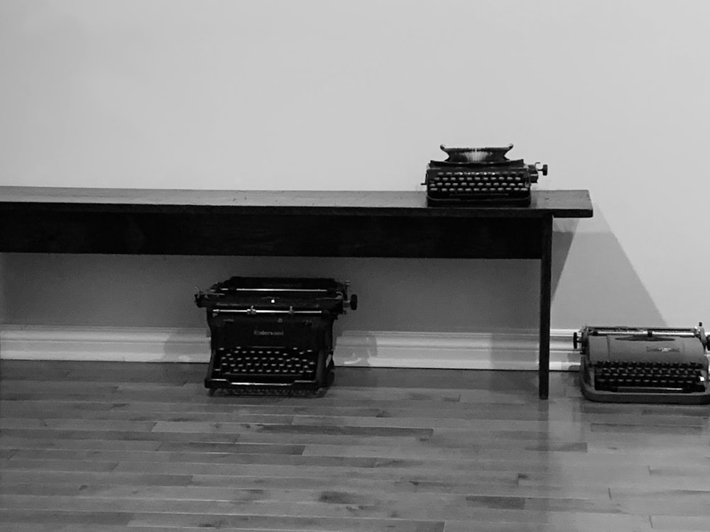 a desk with a typewriter and a typewriter on it