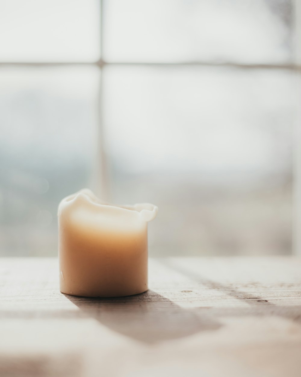 a candle sitting on top of a wooden table