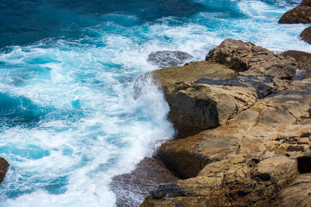 a large body of water near a rocky shore