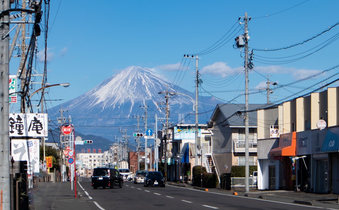 a city street with a mountain in the background, Small town near Mount Fuji