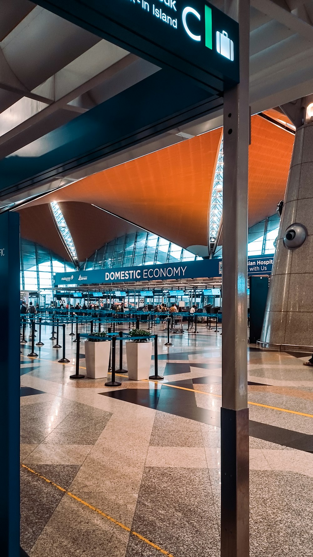 an airport terminal with a sign that says domestic economy