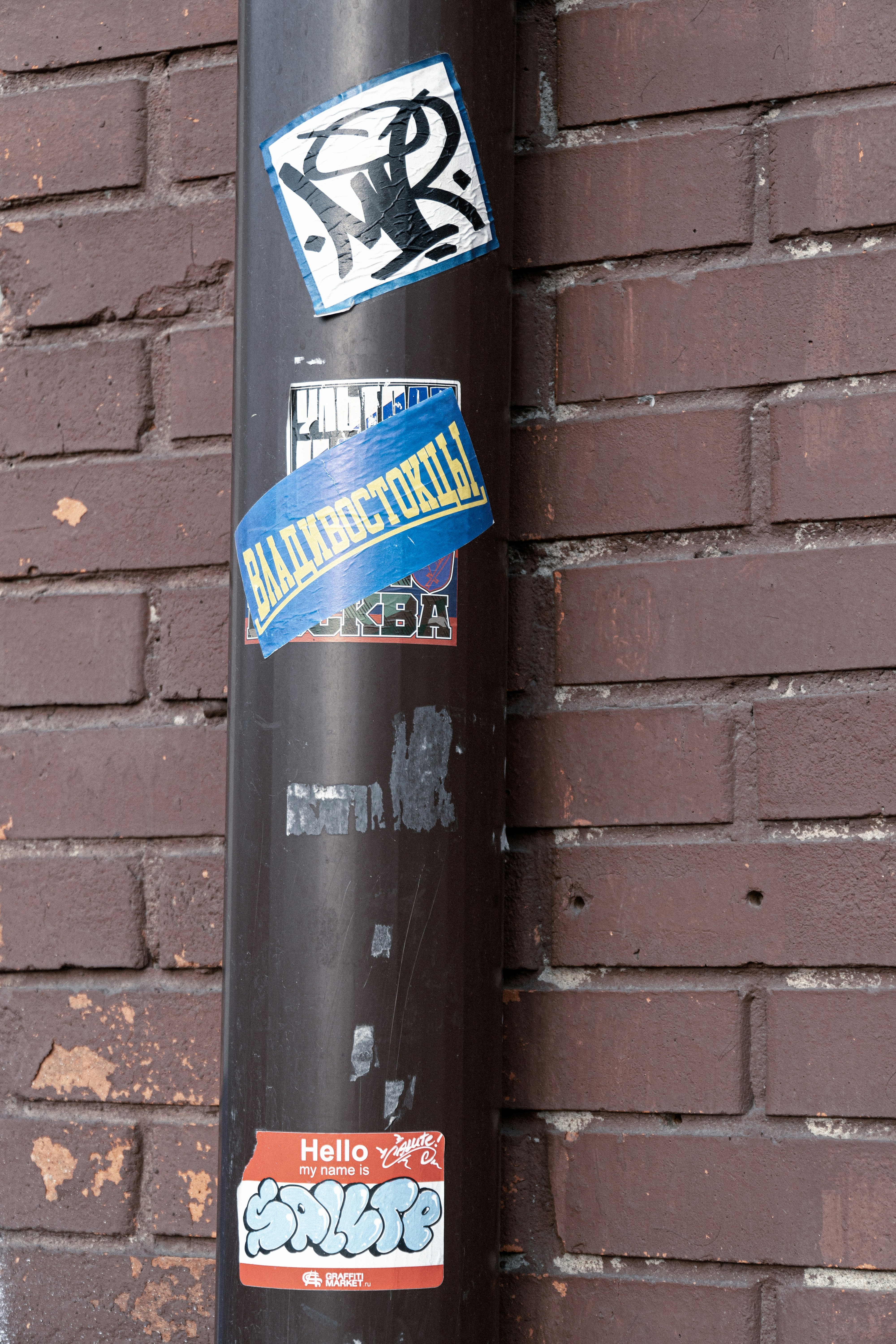a pole with a bunch of stickers on it