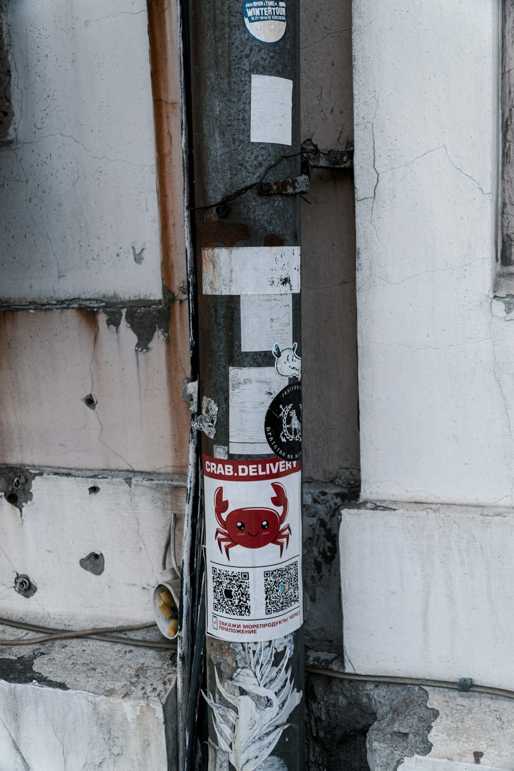 a close up of a pole with stickers on it