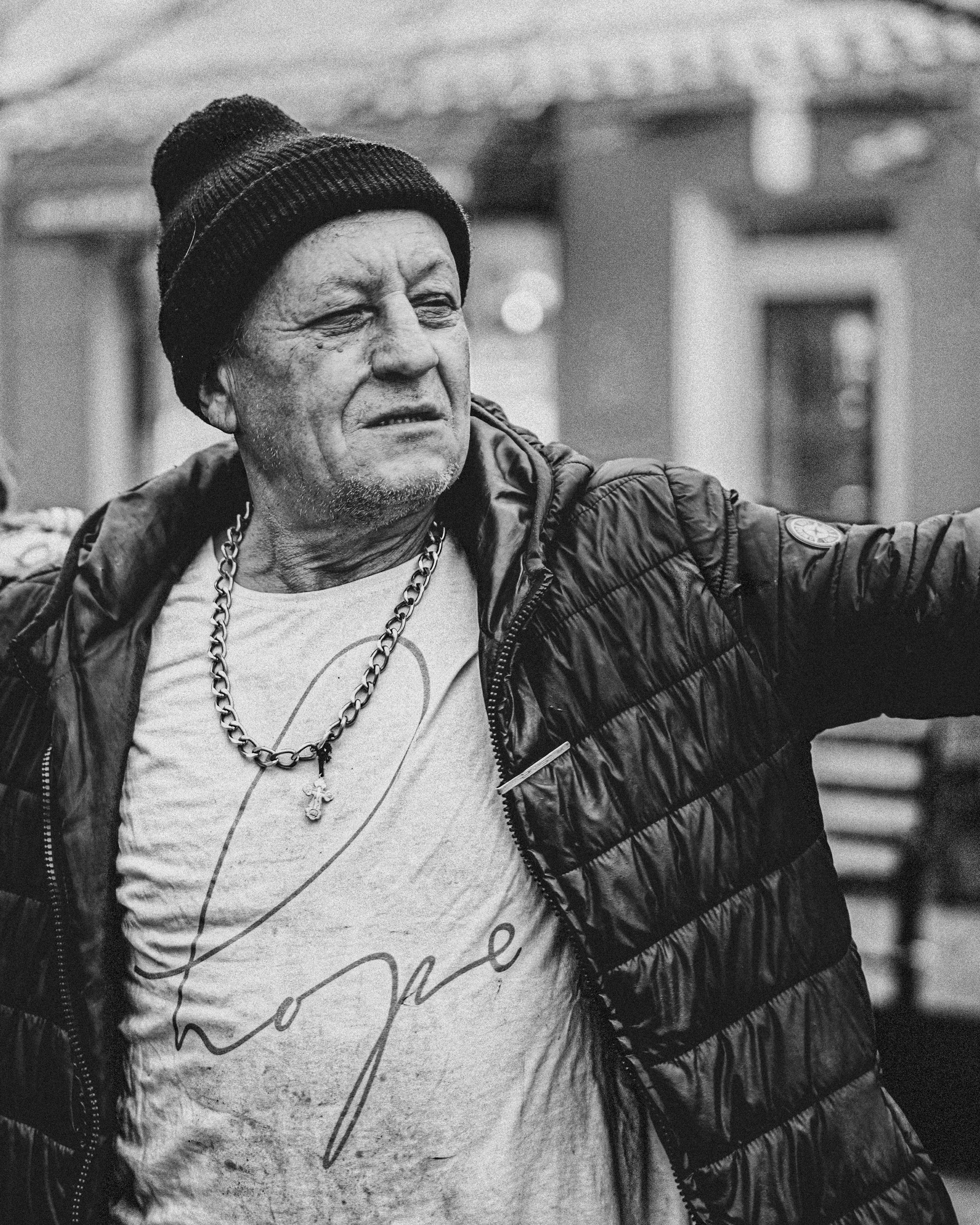 a black and white photo of a man wearing a hat