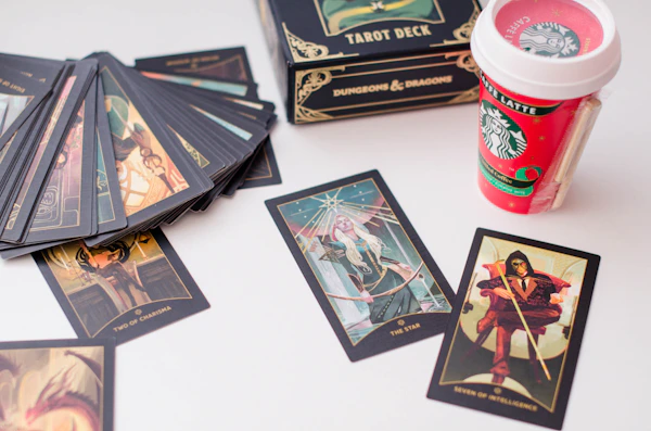 a table topped with lots of cards and a cup of coffee