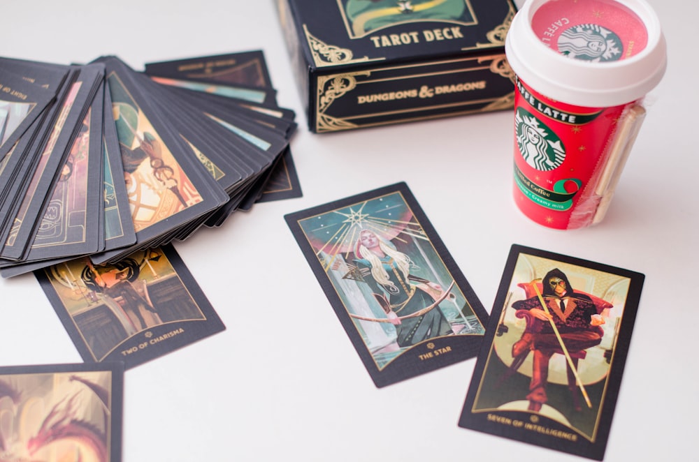 a table topped with lots of cards and a cup of coffee