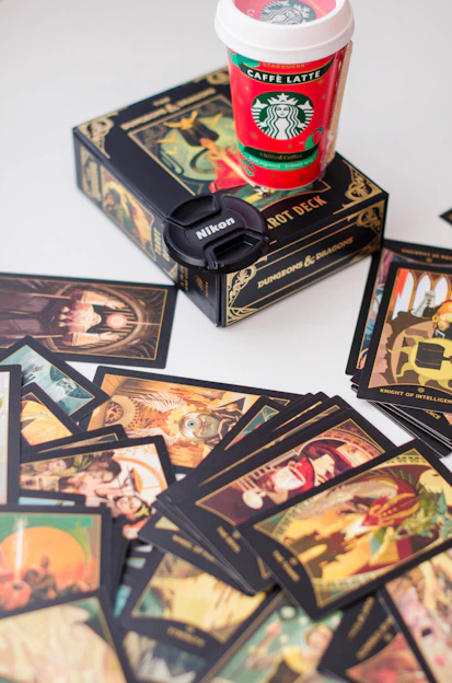 a cup of coffee sitting on top of a pile of cards