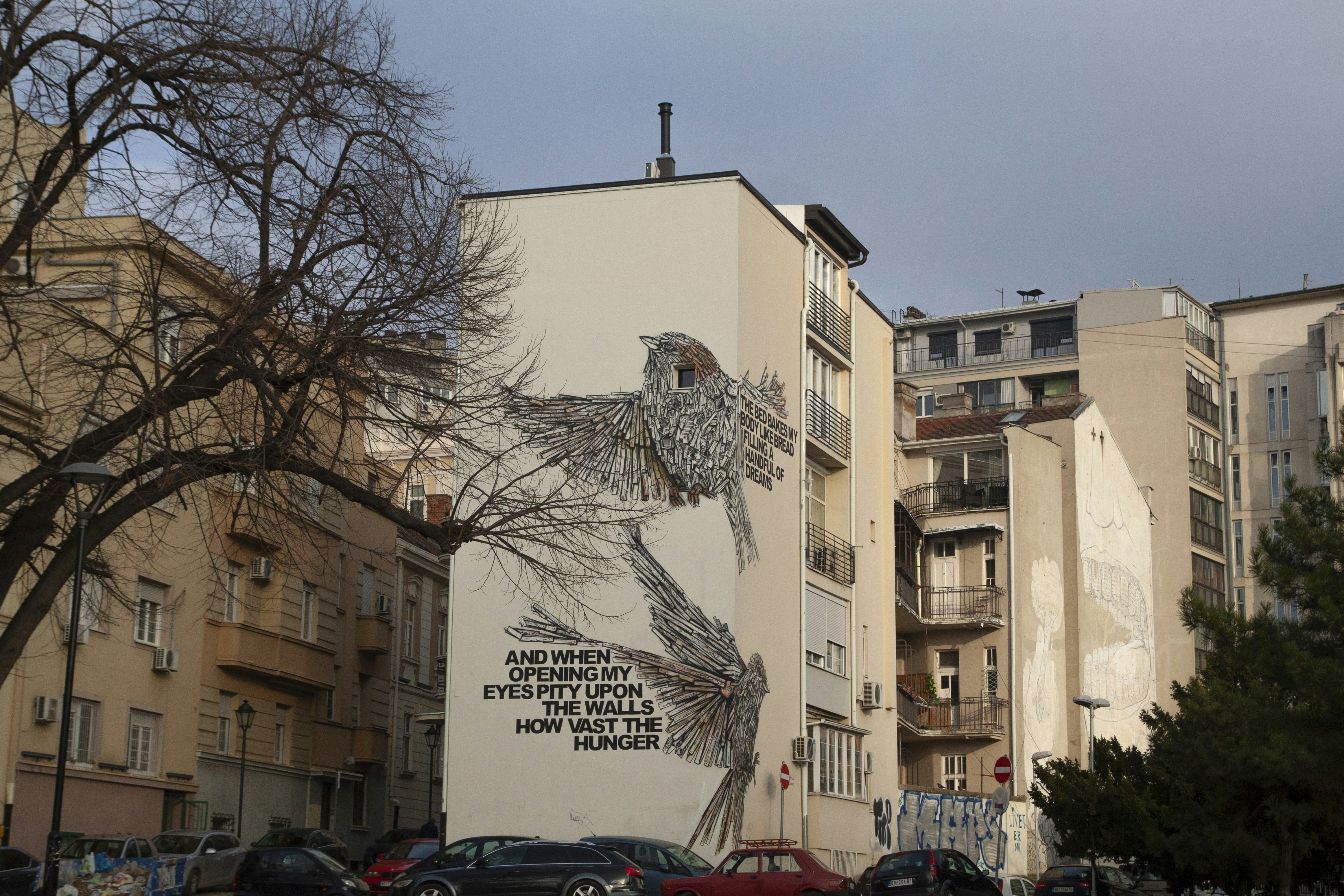 a mural on the side of a building in a city