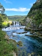 a river with a waterfall in the middle of it
