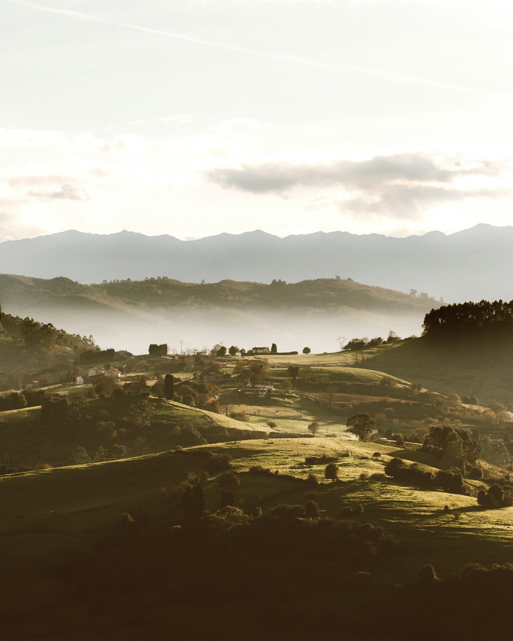 a view of a valley with mountains in the background