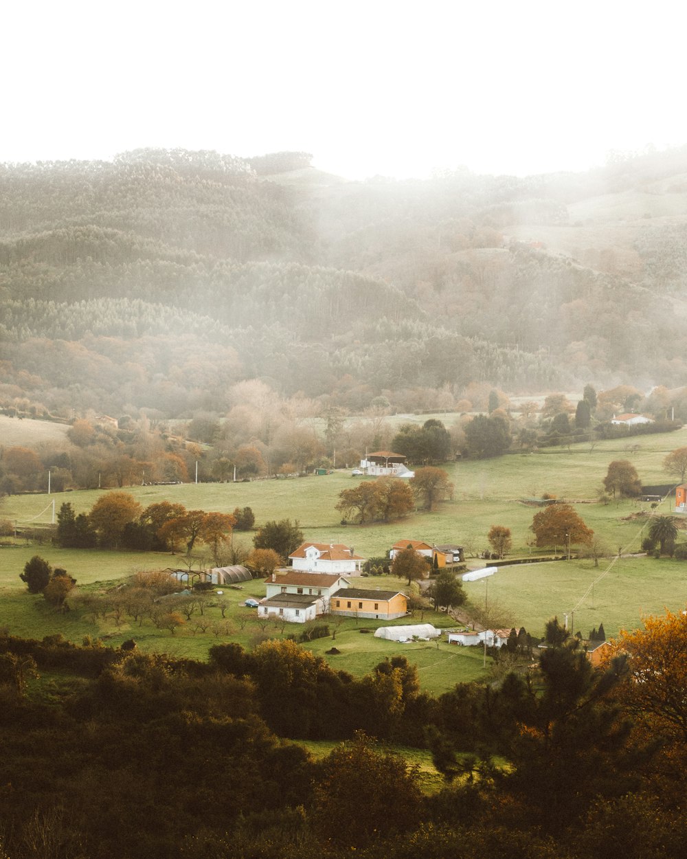 a scenic view of a small town in the mountains