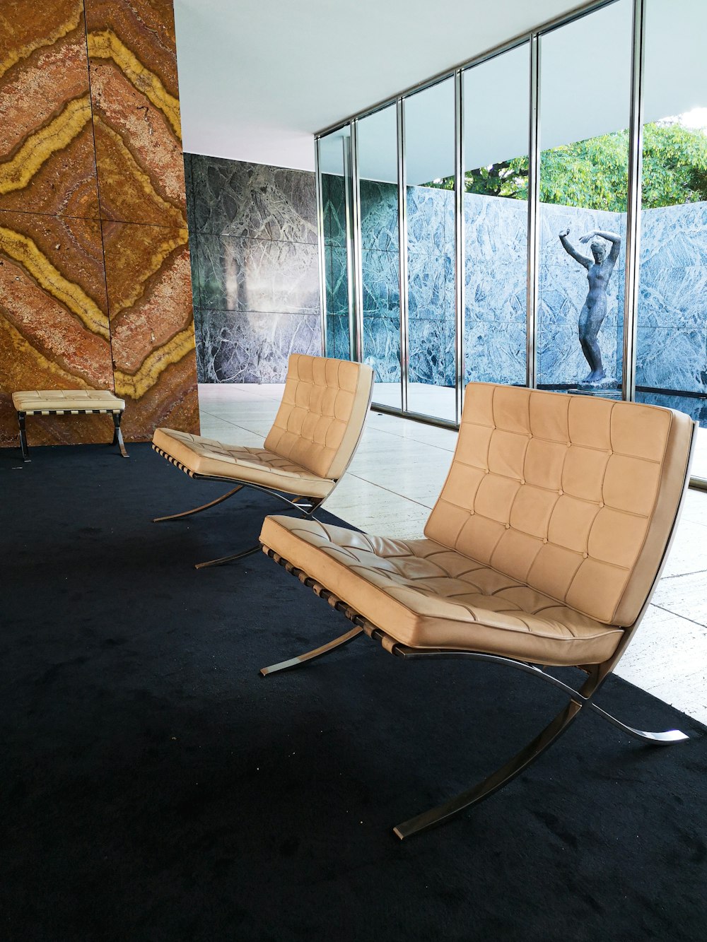 a couple of chairs sitting on top of a black carpet