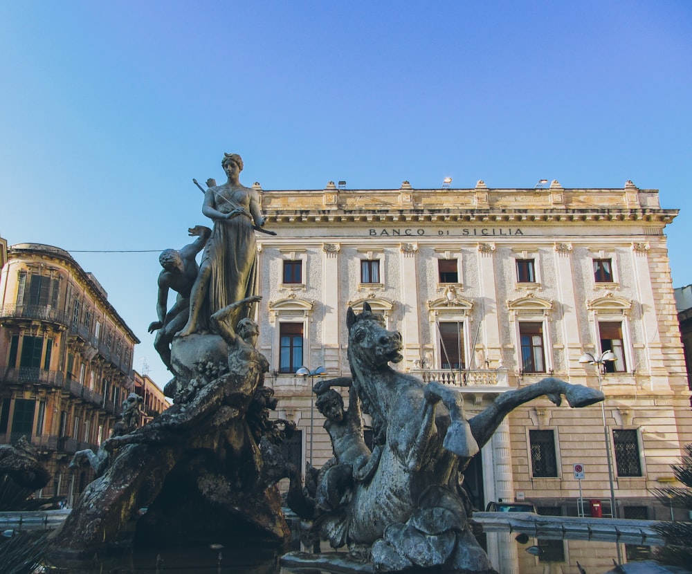 a fountain in front of a large building