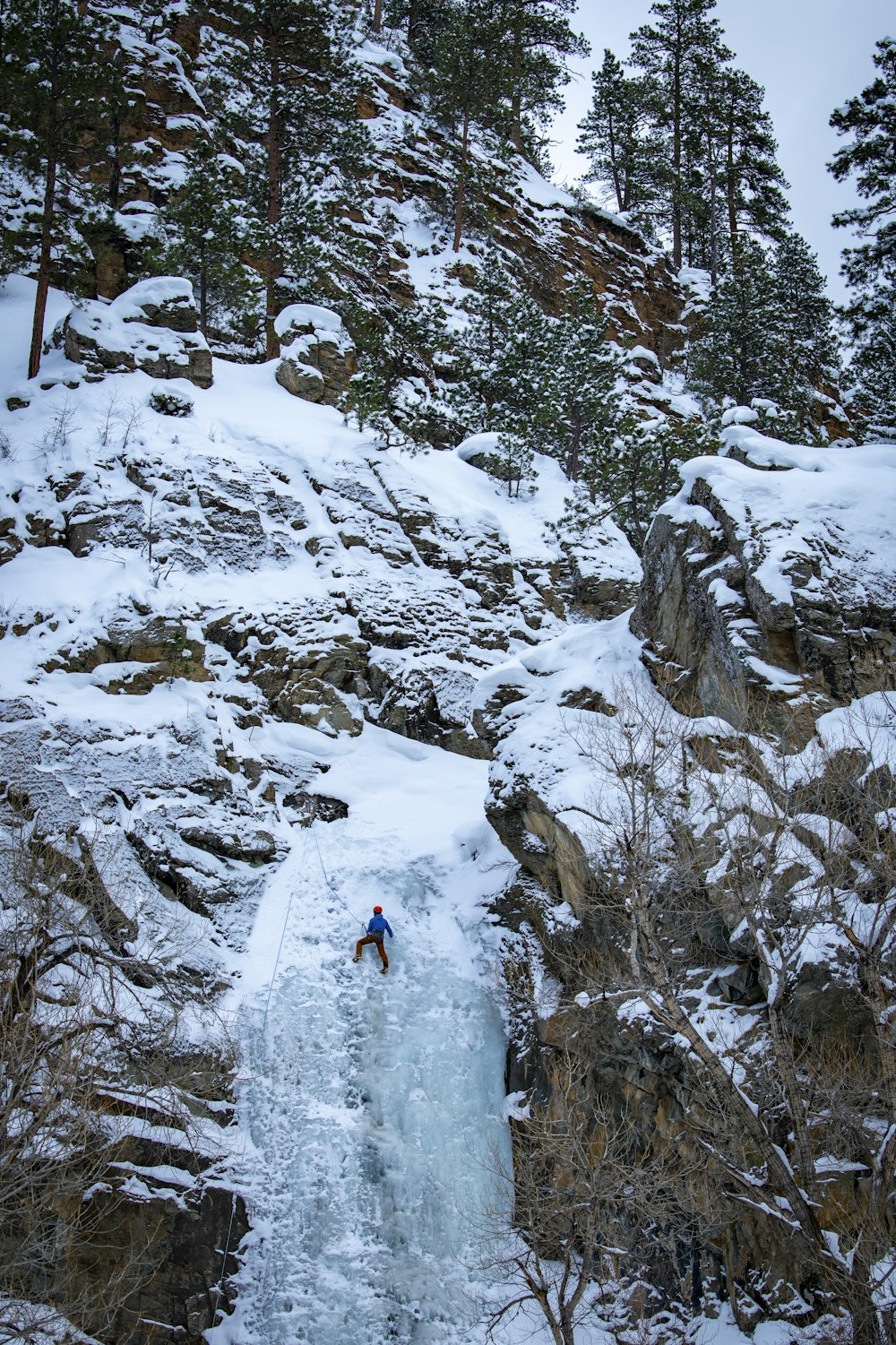 a man is skiing down a small waterfall
