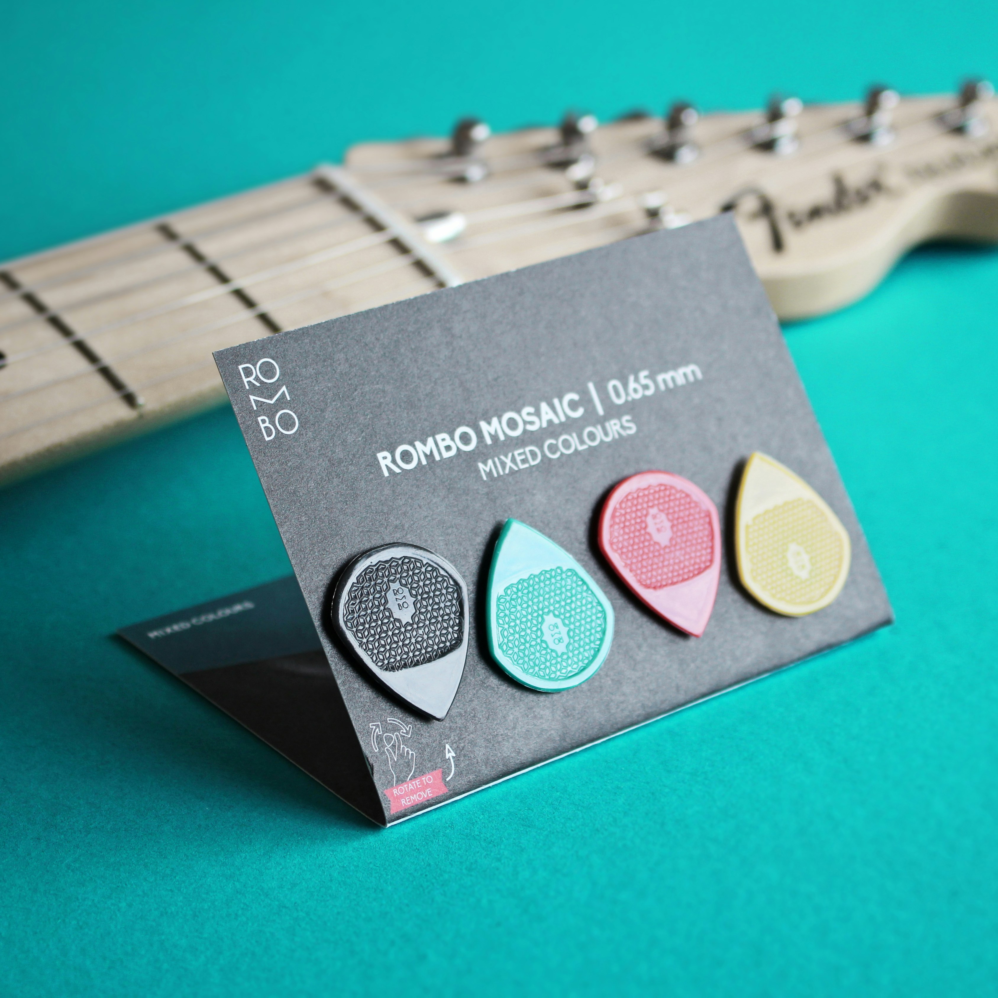 A guitar picker sitting on top of a green table photo – Free Guitar ...