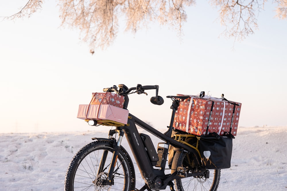 a bicycle with two baskets on the back parked in the snow