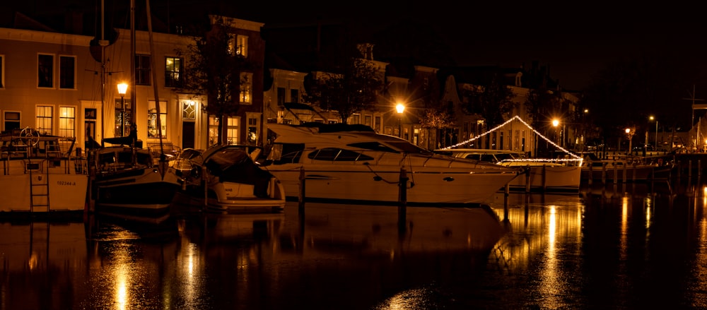 a night scene of boats docked at a marina
