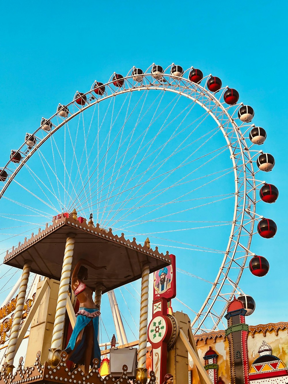 a carnival ride with a ferris wheel in the background