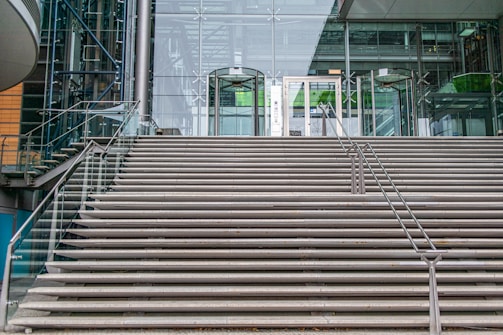 An exterior staircase leading to a contemporary building entrance.