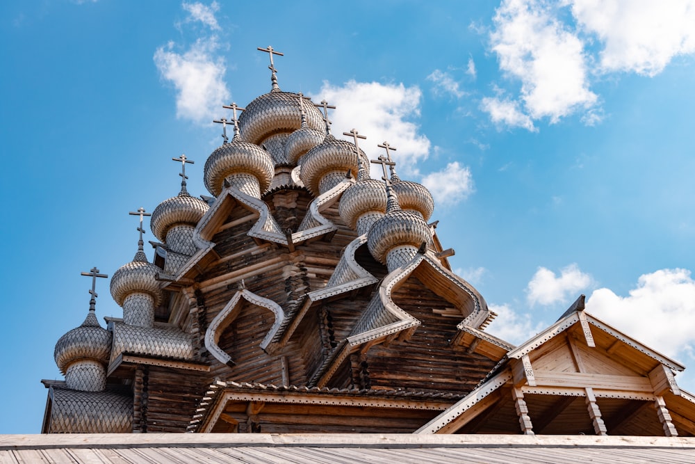 a wooden church with a steeple and crosses on it