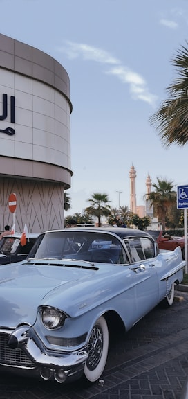 a blue car parked in front of a building