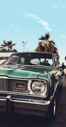 a green car parked in a parking lot
