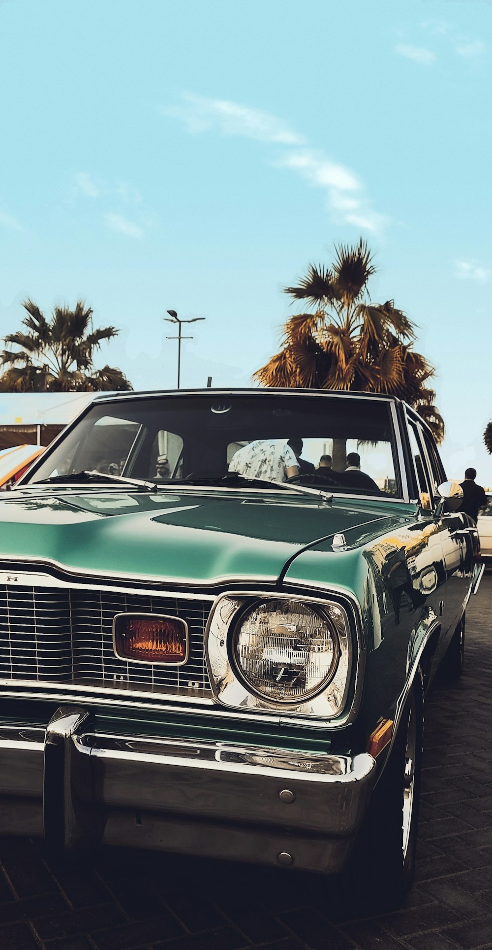 a green car parked in a parking lot