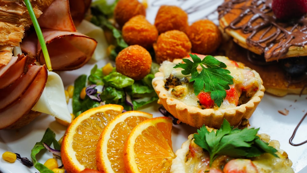 a white plate topped with oranges and other food